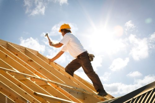 roofer or Carpenter working on Roof on construction site Roofer working on the roof