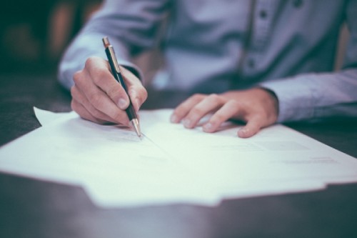 Man filling out Fleet Insurance Papers