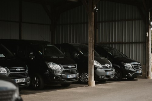 fleet of black ford vans