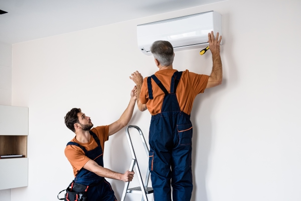 Air Conditioning Engineers Installing Unit