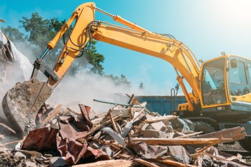 Demolition of building. Excavator breaks old house Building Demoltion with Excavator