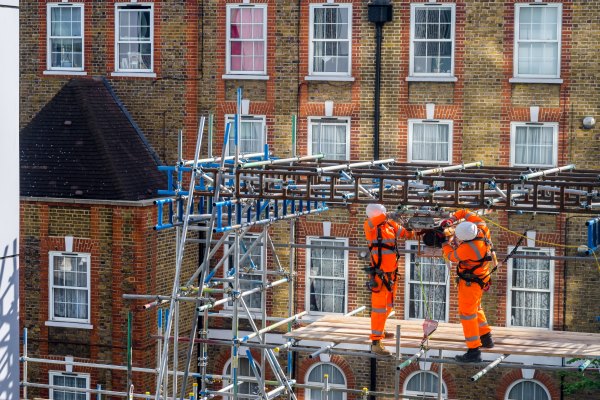 Two scaffolders working on a building site