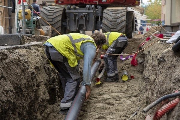 Civil Workers Installing Pipes