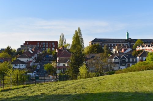 North west London street from atop a hill. No public social gatherings over two people allowed to reduce further spread of coronavirus. Sunshine lifestyle exercise and social distancing across the UK. houses in area of North London