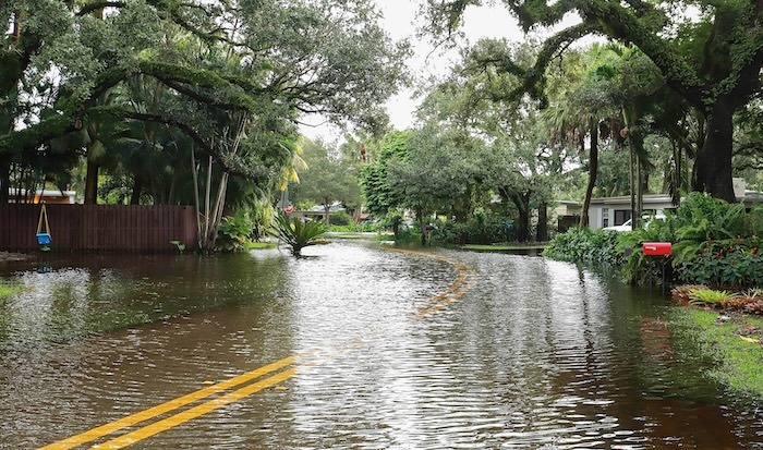 Fort Lauderdale residential neighborhood street floods from Tropical Storm Eta. flooded road stopping construction work