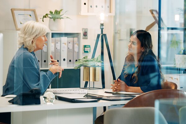 team discussing insurance terms and risks in office at Construction Insure